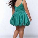 Plus-size model wearing a green sleeveless mini dress with a scoop back, rhinestone & pearl embellished fitted bodice, and a voluminous bubble hem skirt and center back zipper. She is styled with long wavy brown hair, dangling crystal earrings, and nude platform ankle-strap heels, posing against a light gray studio background while.

Sydney's Closet SC8171 in green