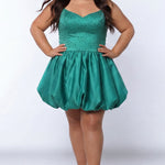 Plus-size model wearing a emerald green sleeveless mini dress with a V-neckline, rhinestone & pearl embellished fitted bodice, and a voluminous bubble hem skirt. She is styled with long wavy brown hair, dangling crystal earrings, and nude platform ankle-strap heels, posing against a light gray studio background while her hands are on her hips.

Sydney's Closet SC8171 in green