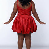 Plus-size model wearing a red sleeveless mini dress with a scoop back, rhinestone & pearl embellished fitted bodice, and a voluminous bubble hem skirt and center back zipper. She is styled with long wavy black hair, dangling crystal earrings, and nude platform ankle-strap heels, posing against a light gray studio background while.

Sydney's Closet SC8171 in red