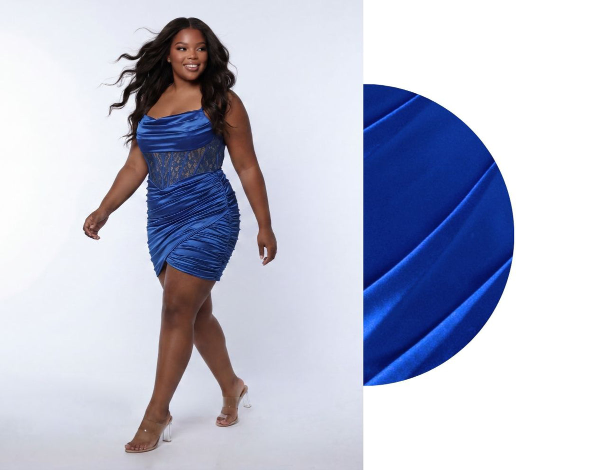 Woman wearing a blue strapless dress with lace detailing on a white background