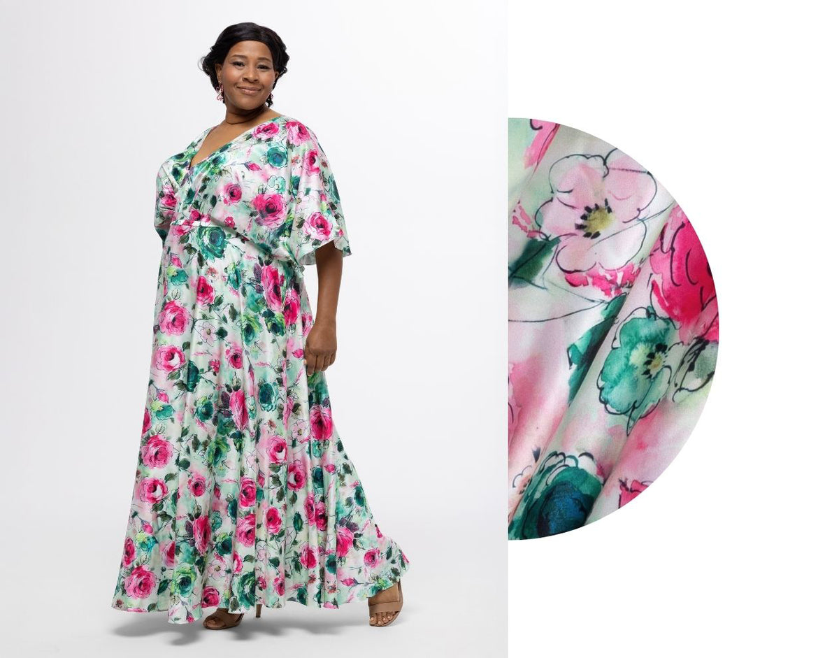 Woman wearing a floral dress with a close-up of the fabric showing pink flowers.