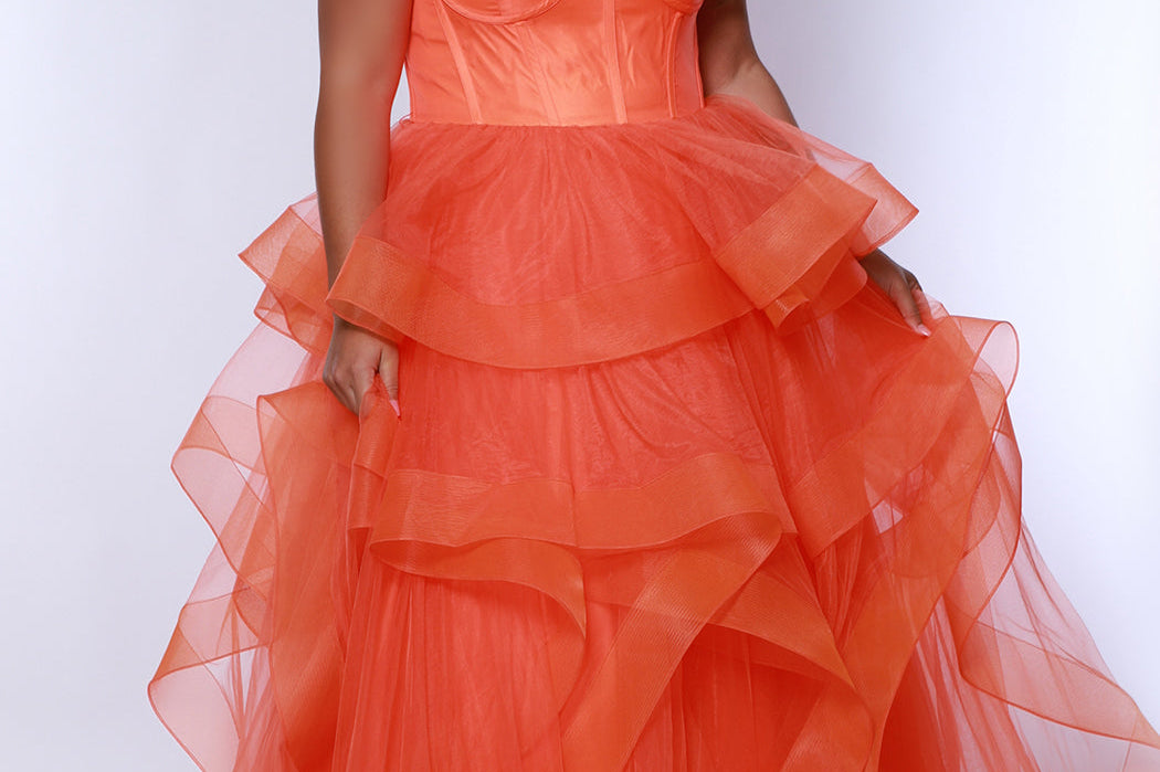 Tease prom TE2420 Orange. Tulle ruffles on a tiered skirt, exposed boning on bodice, strapless, ballgown.