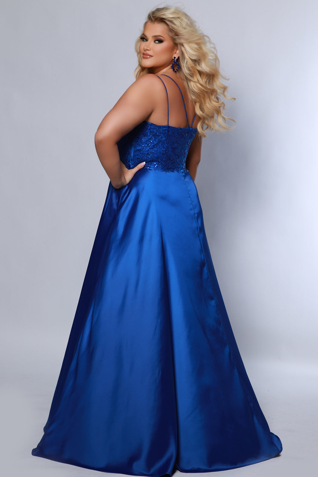 Best selling Tease Prom TE2437 plus size, A-line prom dress with double spaghetti straps, V-neckline, lace bodice and satin skirt with pockets and slit. Available in purple, blue, black, red, or green. 