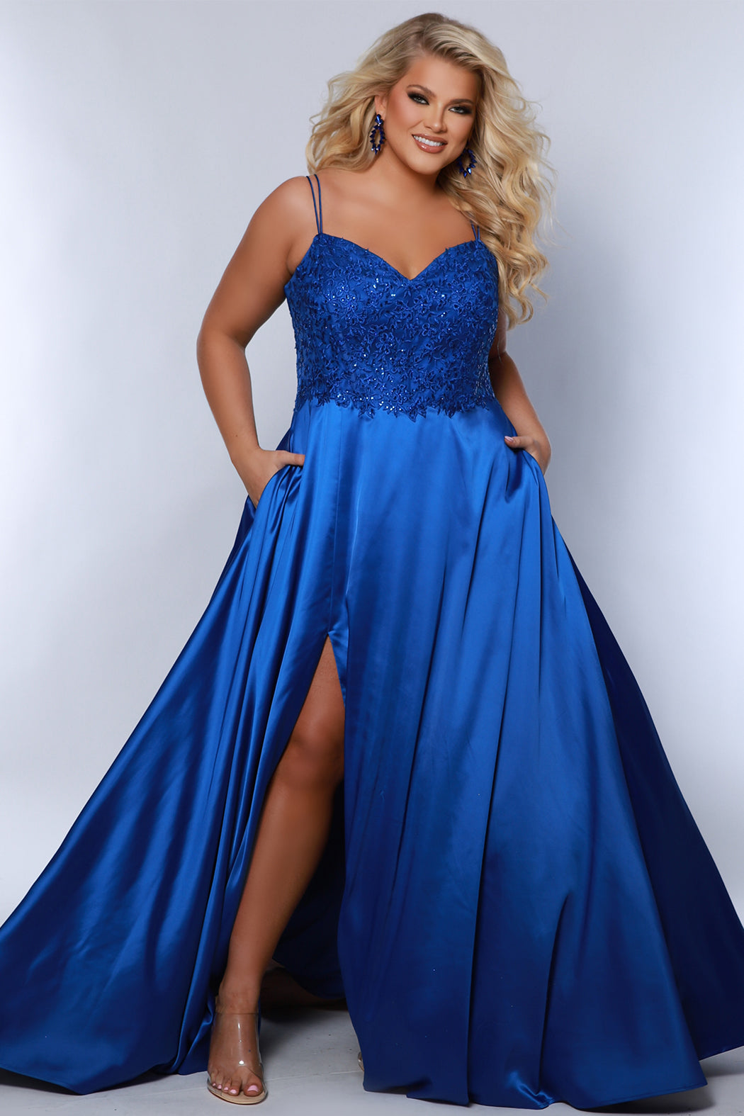 Best selling Tease Prom TE2437 plus size, A-line prom dress with double spaghetti straps, V-neckline, lace bodice and satin skirt with pockets and slit. Available in purple, blue, black, red, or green. 
