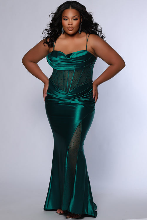 Sexy plus size fitted prom dress with double spaghetti straps, pleated bodice with optional bodice lining.  Exposed boning with hot fix stones on basque waistline.  Slim fitted skirt with ruching. High slit filled in with mesh and hot fix stones. Tease Prom style TE2516 avialable in berry, forest and navy. 