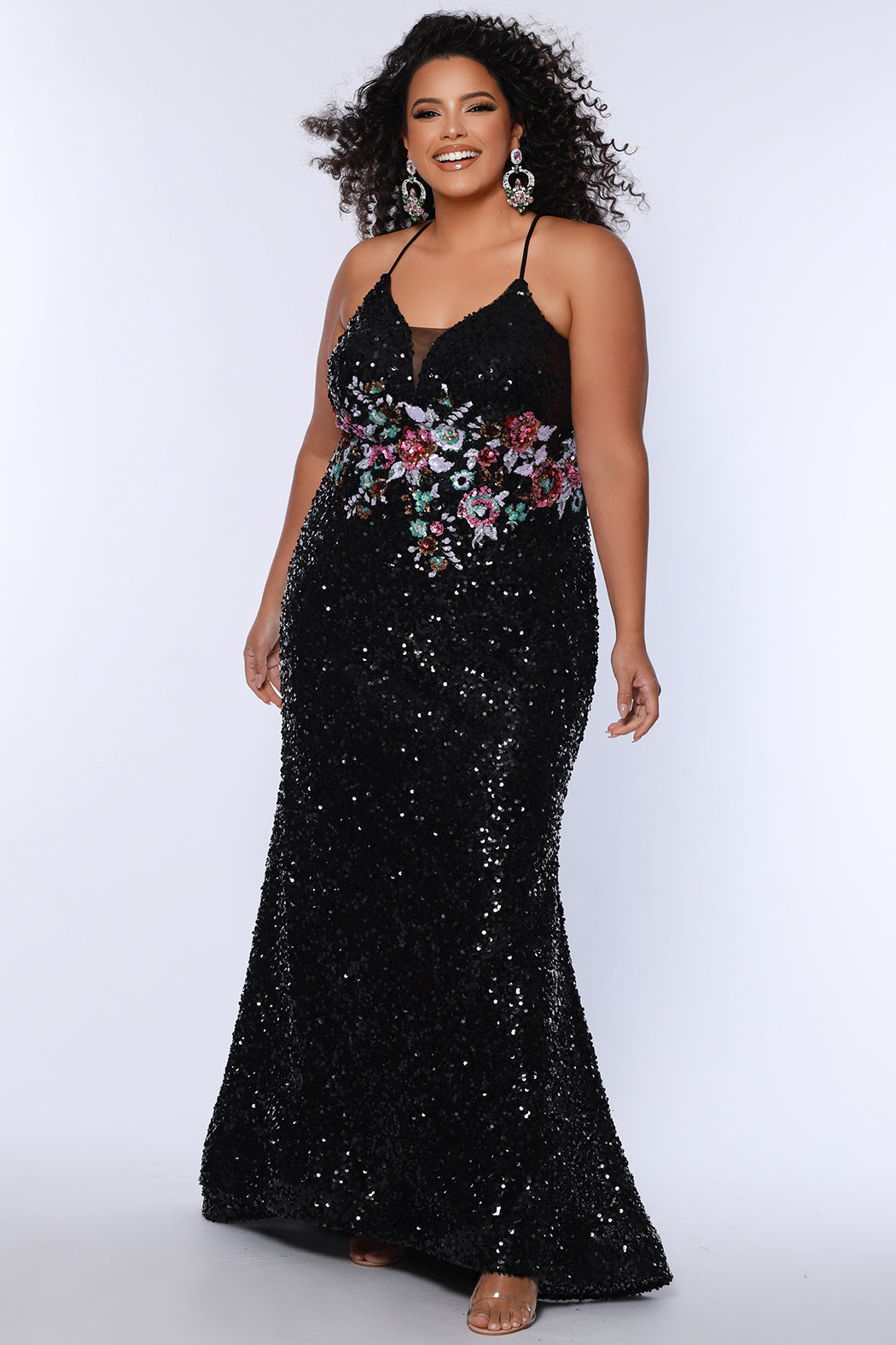 Tease Prom style TE2524 available in black with ivory floral sequin motif.  Spaghetti straps into a razor back with keyhole cutout. Deep V-neckline with black mesh. Slim fitted skirt with sweep train and horsehair hem.