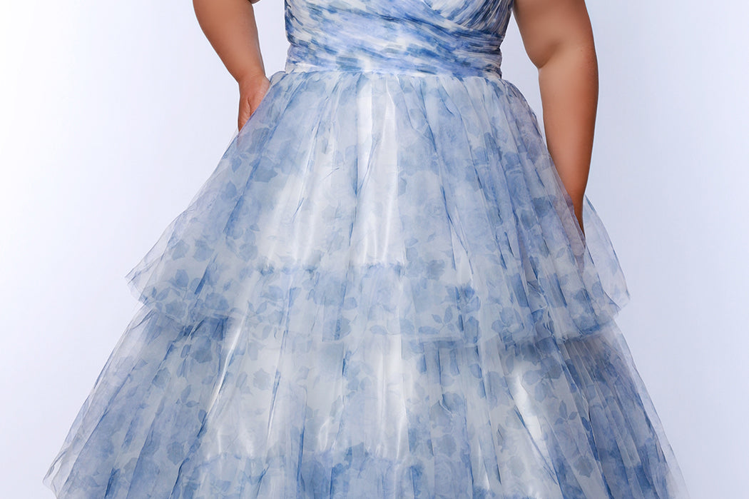 Best selling plus size floral tiered ballgown dress style TE2525 by Tease Prom.  Double spaghetti straps on pleated V-neckline bodice with tiered ball gown skirt in floral print tulle. Available in black floral or blue floral in sizes 14-32. 