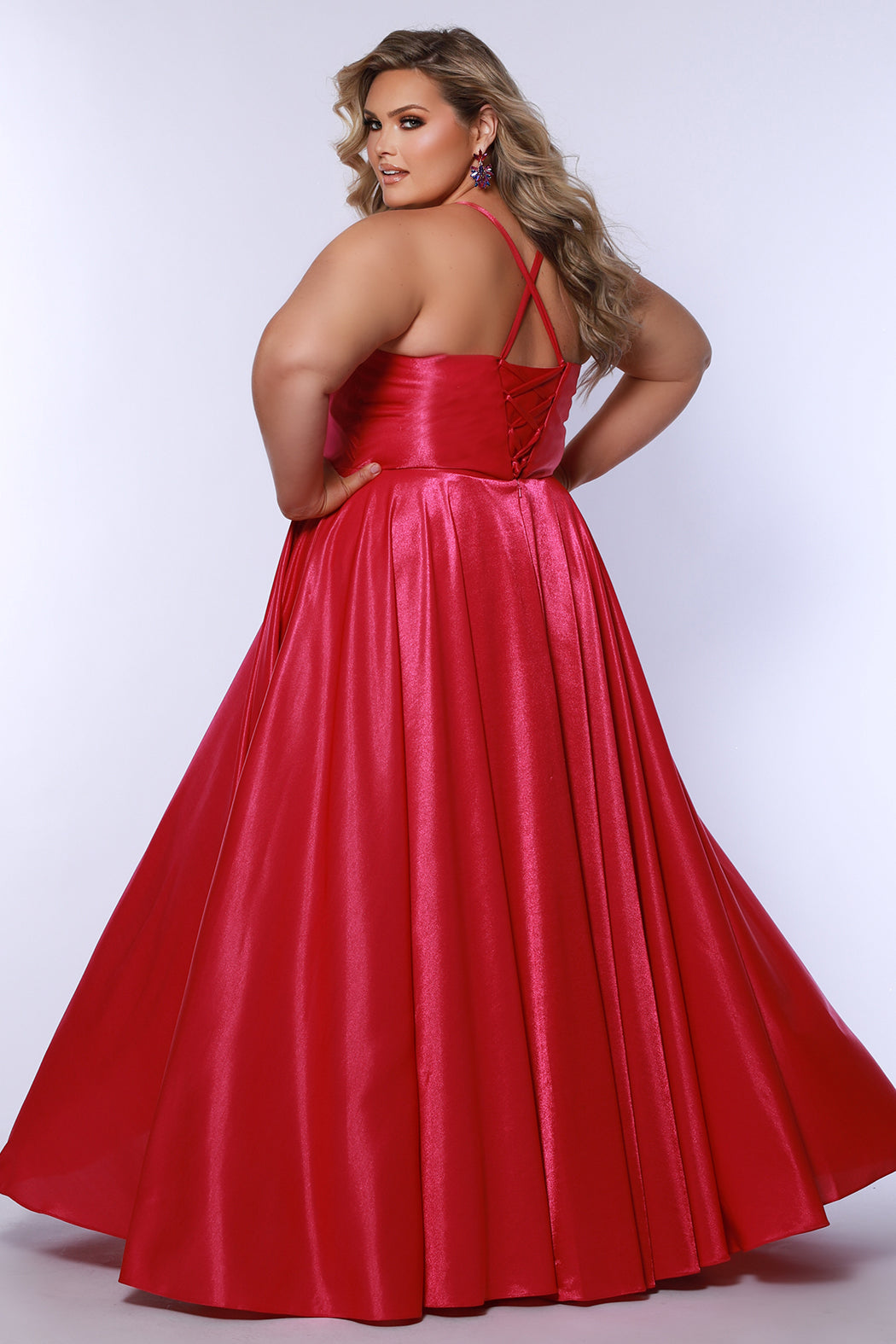 Tease Prom style TE2532 is available in black, blue, pink, purple or red in plus sizes 14-32.  Pleated draped bodice with exposed boning and optional bodice lining. Full A-line skirt with pockets. Straps go into lace up ties with modesty panel on the back. 