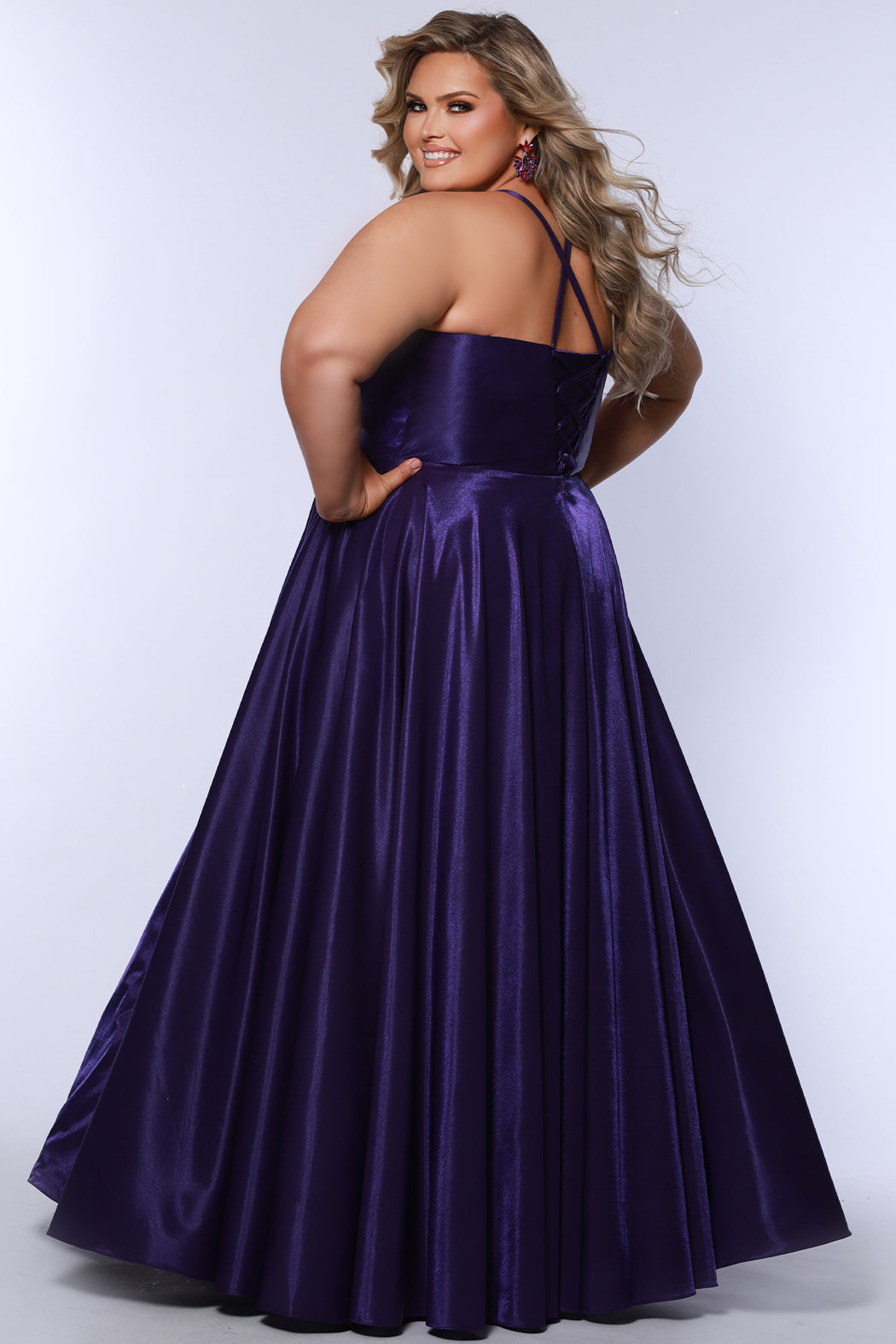Tease Prom style TE2532 is available in black, blue, pink, purple or red in plus sizes 14-32.  Pleated draped bodice with exposed boning and optional bodice lining. Full A-line skirt with pockets. Straps go into lace up ties with modesty panel on the back. 