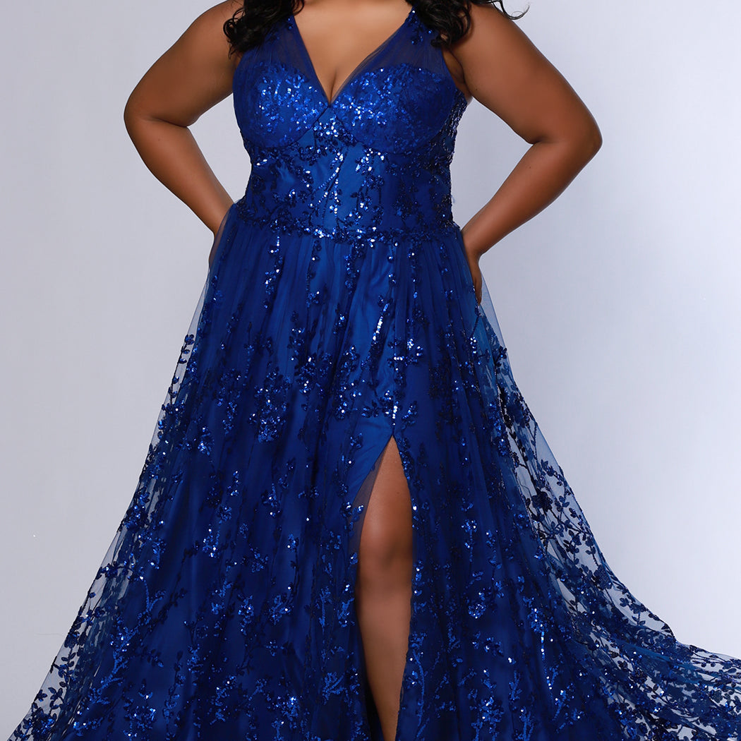 Plus size prom dress style TE2537 by Tease Prom available in Sapphire blue or Orchid purple.  Pleated illusion straps cover a sweetheart bodice with exposed corset boning. Full A-line skirt with slit and glitter sequin appliques on tulle mesh.