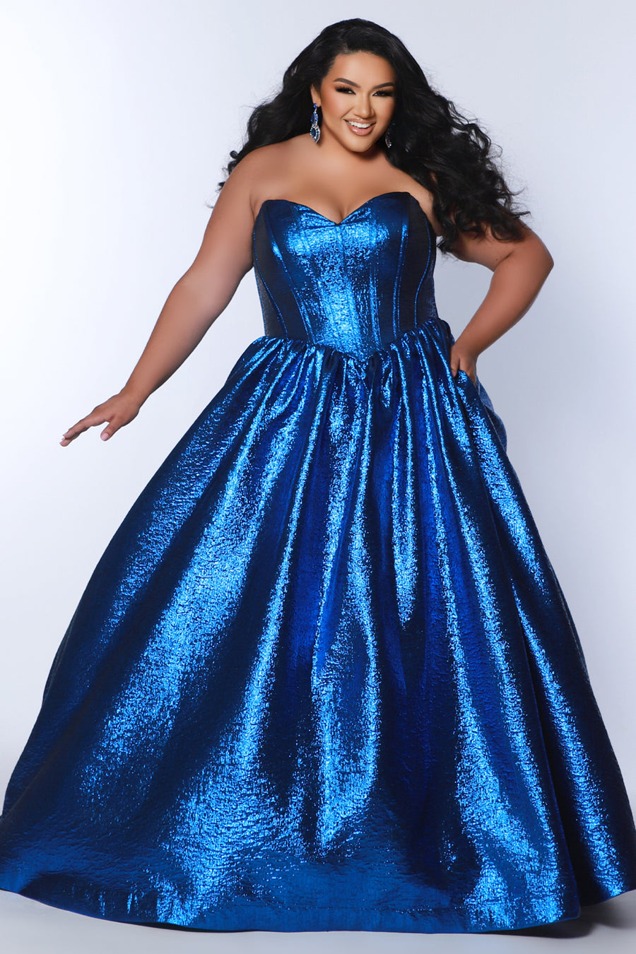 Tease Prom for Sydney's Closet style TE2539 available in ruby red or sapphire blue. Plus size ballgown with strapless sweetheart bodice, exposed boning, basque waist and full A-line skirt with pockets. 