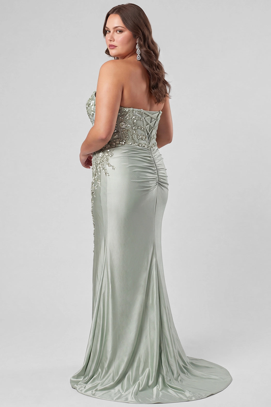 Tease Prom style TE2608 in Sage Green.

Strapless sweetheart plus size fitted gown. Exposed boning with 3D floral appliques and sequin detail on stretch satin. Basque waist, ruched skirt and left leg slit. Lace up back with half zipper, sweep train. Available in sizes 14-28 in Capri Blue, Sage Green and Orchid Purple. 
