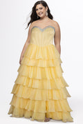 A teen modeling a strapless formal dress with a beaded sweetheart neckline, exposed corset boning, basque waistline and a full tiered chiffon ruffle skirt, photographed against a light gray studio background.

TE2611 in canary yellow by Tease Prom, exclusively plus size prom dresses designed by Sydney's Closet.