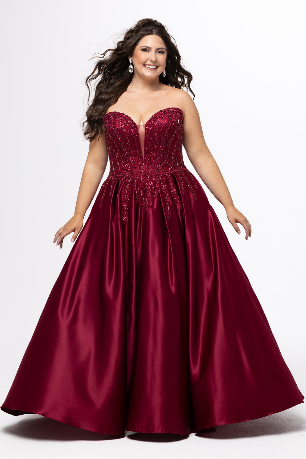 Tease Prom style TE2619 in Burgundy. 

Strapless sweetheart plus size satin ballgown. Deep v neckline with mesh insert. Exposed boning, heavy beaded detail and natural waistline. Pleated A-line skirt with crinoline. No slit, lace up back and half zipper. Available in sizes 14-32 in Burgundy, Black and dark blue. 