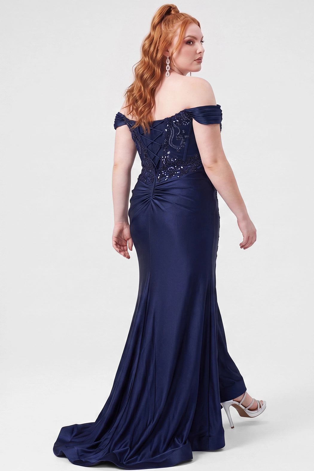 Tease Prom style TE2625 in Navy blue. 

Strapless satin fitted plus size gown.  Stretch satin, Sequin appliques, Bugle beads and circle beads. Sweetheart neckline with Detachable drape sleeves, pleated. Optional bodice lining and Exposed corset boning. Basque waistline and Ruched bum. Fitted skirt with Slit on left leg. Lace up back with half zipper. Available in Emerald green, Navy blue, Lipstick pink and Black sizes 14-28. 