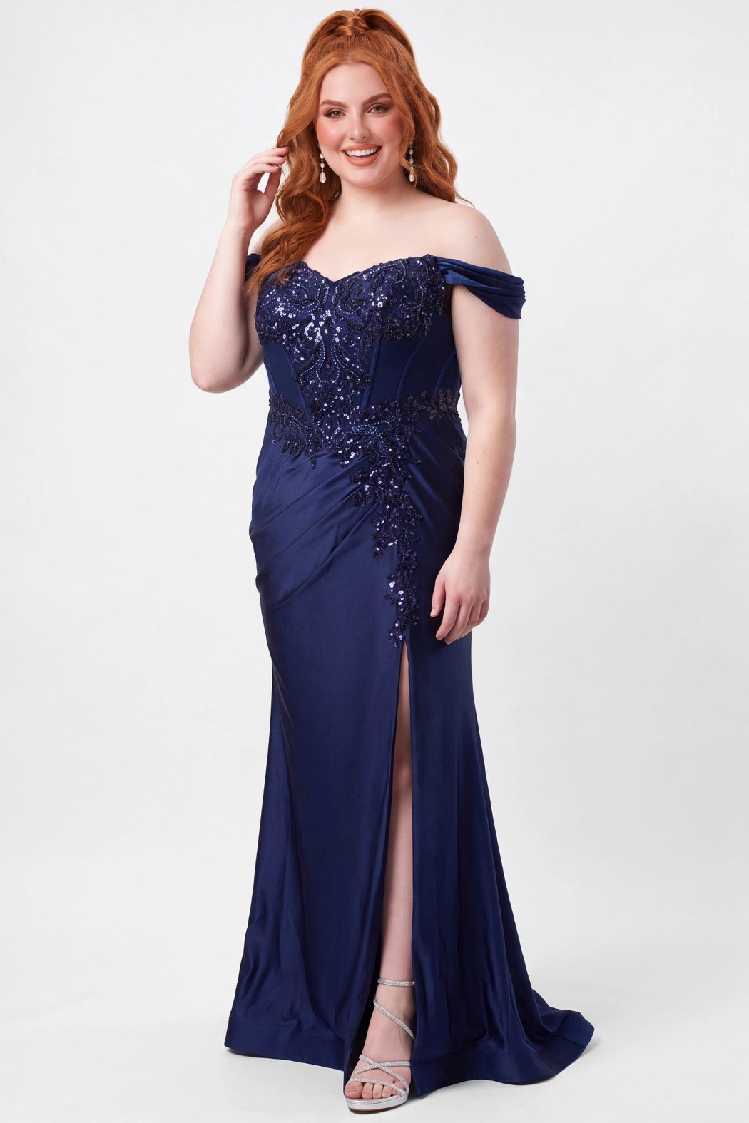 Tease Prom style TE2625 in Navy blue. 

Strapless satin fitted plus size gown.  Stretch satin, Sequin appliques, Bugle beads and circle beads. Sweetheart neckline with Detachable drape sleeves, pleated. Optional bodice lining and Exposed corset boning. Basque waistline and Ruched bum. Fitted skirt with Slit on left leg. Lace up back with half zipper. Available in Emerald green, Navy blue, Lipstick pink and Black sizes 14-28. 