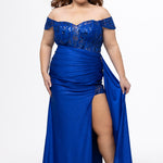 Tease Prom style TE2629 in Sapphire blue. 

Slim fitted plus size gown. Sweetheart neckline, Exposed corset boning, Natural waistline on front, basque waistline at back. Ruched skirt, Left leg slit with appliqués on net, Drape flyaway on waist. Detachable lace covered drape straps. Lace up back with modesty panel. Available in Blue, pink, red and black sizes 14-24. 