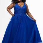 Tease Prom style TE2630 in Blue. 

A-line sparkle tulle plus size ballgown. Beaded & glitter appliques, V-neckline, Illusion straps, Tone-on-tone mesh insert, Natural waistline, Pockets. Available in Burgundy, forest and blue and black in sizes 14-32.

