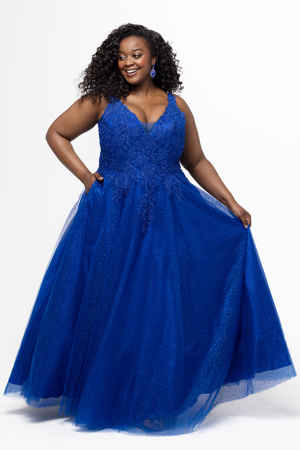 Tease Prom style TE2630 in Blue. 

A-line sparkle tulle plus size ballgown. Beaded & glitter appliques, V-neckline, Illusion straps, Tone-on-tone mesh insert, Natural waistline, Pockets. Available in Burgundy, forest and blue and black in sizes 14-32.
