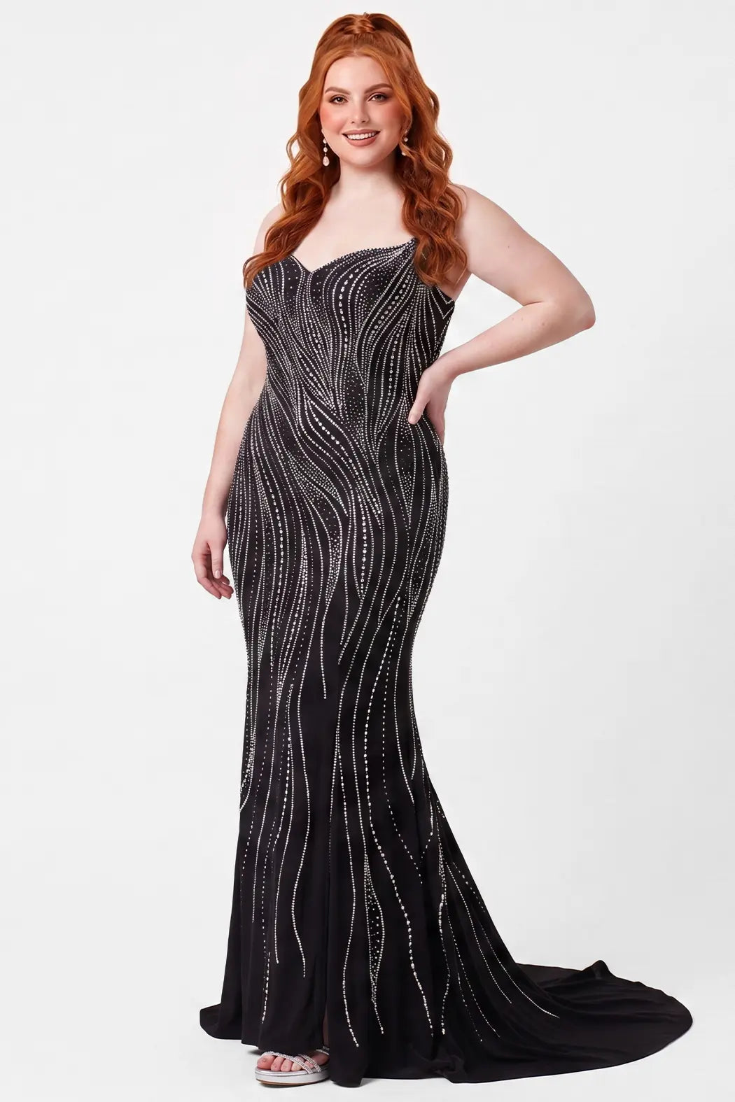 A teenager modeling a strapless black slim fitted evening gown with silver beaded vertical lines and a slight train, photographed against a plain light gray studio background.

TE2714 in moonstone black by Tease Prom, exclusively plus size prom dresses designed by Sydney's Closet.