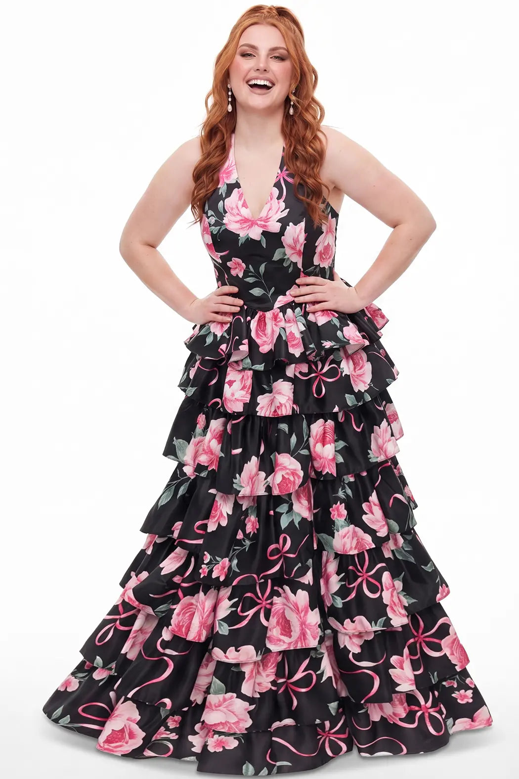 A teen modeling a sleeveless black halter gown with a tiered ruffle skirt, featuring a pink and green floral print on black satin, against a plain white background.

TE2720 in black floral by Tease Prom, exclusively plus size prom dresses designed by Sydney's Closet.