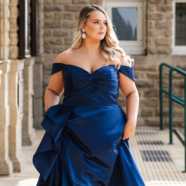 Sydney's Closet UK Capsule collection UK2606 navy blue satin plus size prom dress

Woman wearing a blue off-shoulder gown standing outdoors.