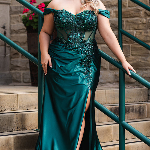 Sydney's Closet UK Capsule collection UK2616 emerald green plus size prom dress

Woman in a teal evening gown standing on steps with a stone wall and green railing in the background.
