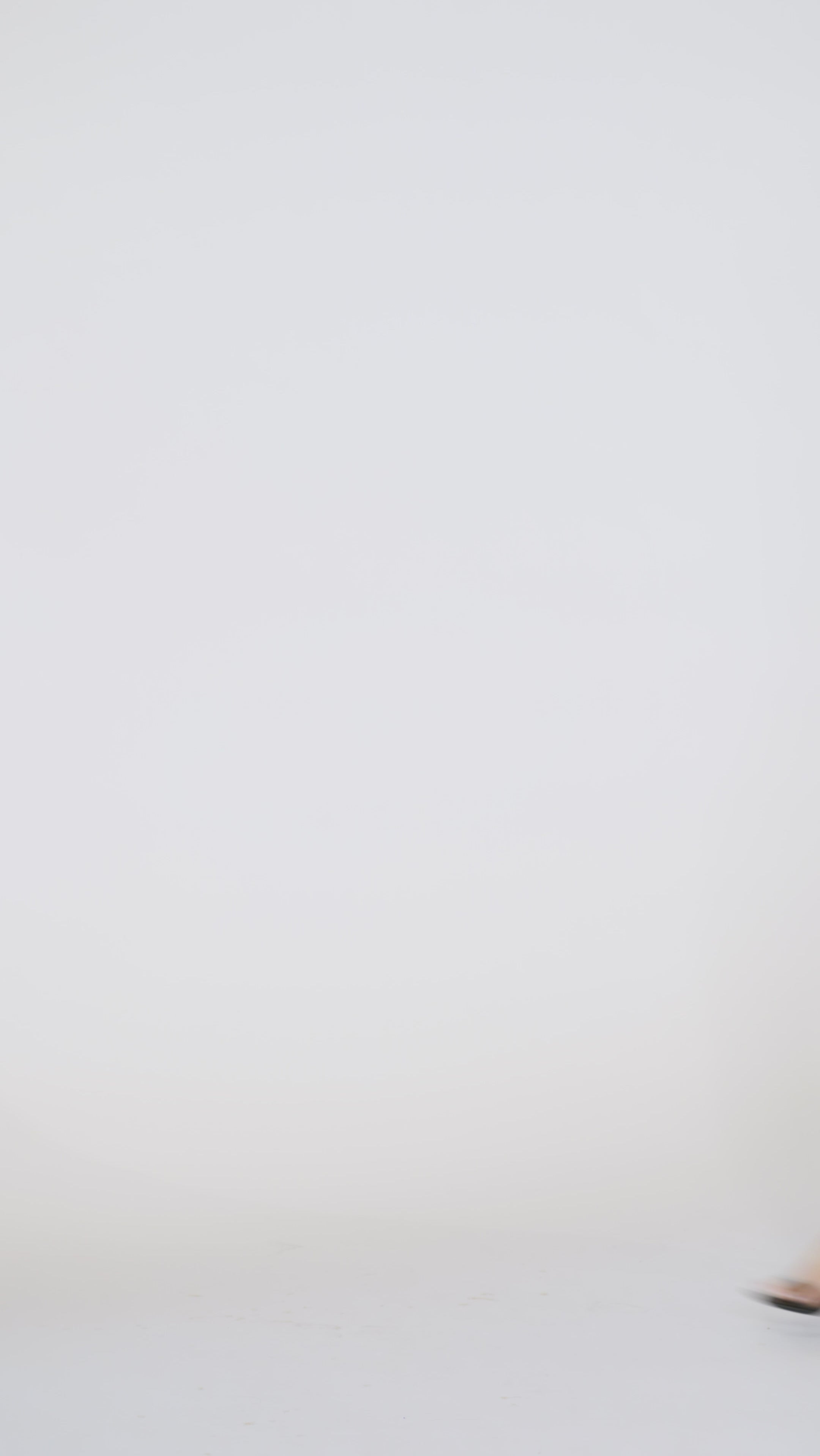 Woman models a black sleeveless sequin mini dress with a V-neckline, turning to show the back before walking off screen.