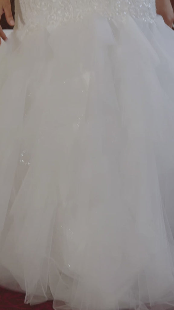 Michelle Bridal MB2411 Ivory. Embroidered lace appliques over soft bridal tulle, sparkle bridal tulle, Embellished with clear sequins, bugle beads, geometric stone, Satin lining, Mermaid silhouette, Boned bodice, Sweetheart neckline, Beaded spaghetti straps, Tiered tulle, Mermaid skirt, Center back zipper