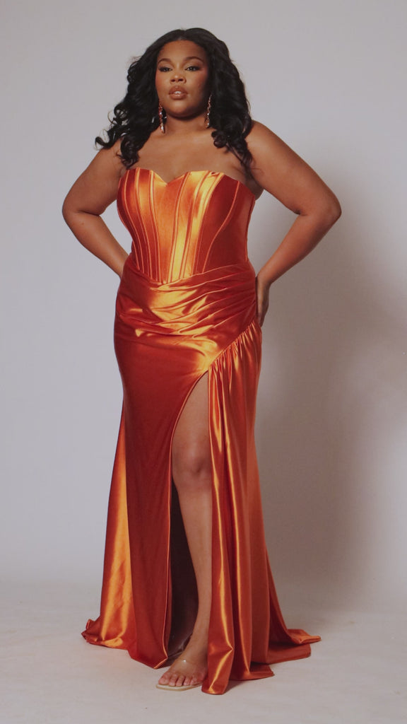 Plus size strapless, sweetheart neckline slim fitted prom dress TE2503 by Tease Prom. Avialablit in cobalt blue, magenta pink and sunset orange. Corset exposed boning on the bodice, basque waistline, slit with ruching and sweep train. 