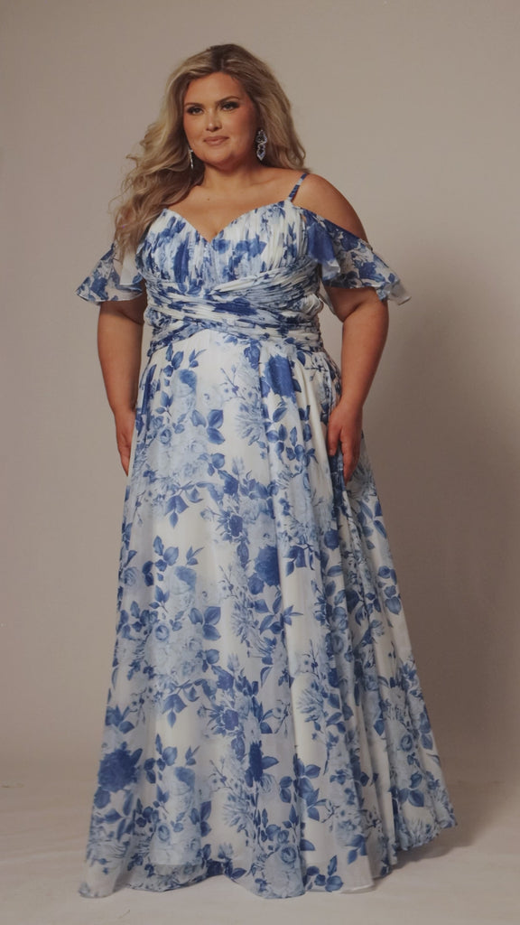 Plus size picnic dress in blue and white floral chiffon print. Criss-cross pleated bodice with spaghetti straps and drape sleeve. A-line skirt and center back zipper. Style SC7421 by Sydney's Closet. 