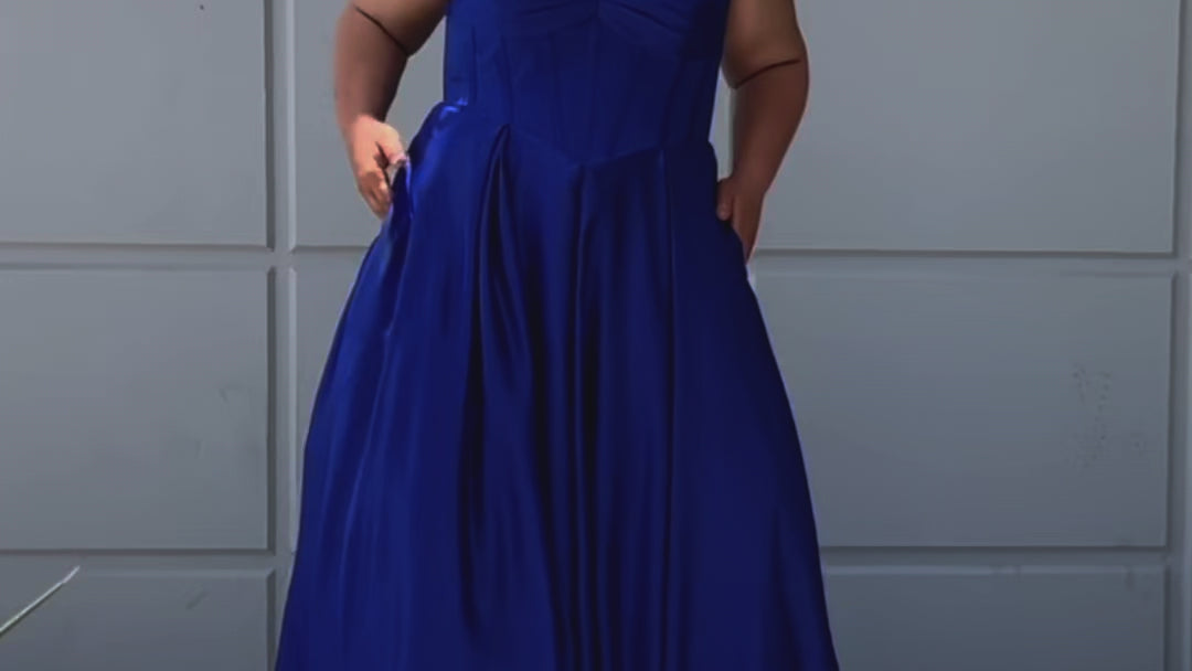 Long formal satin ballgown style SC7400 by Sydney's Closet. Available in sizes 14-32 in colors cobalt blue, onyx black and ruby red.  Pleated bodice with exposed boning, detachable pleated drape sleeves, basque waist and pockets.  