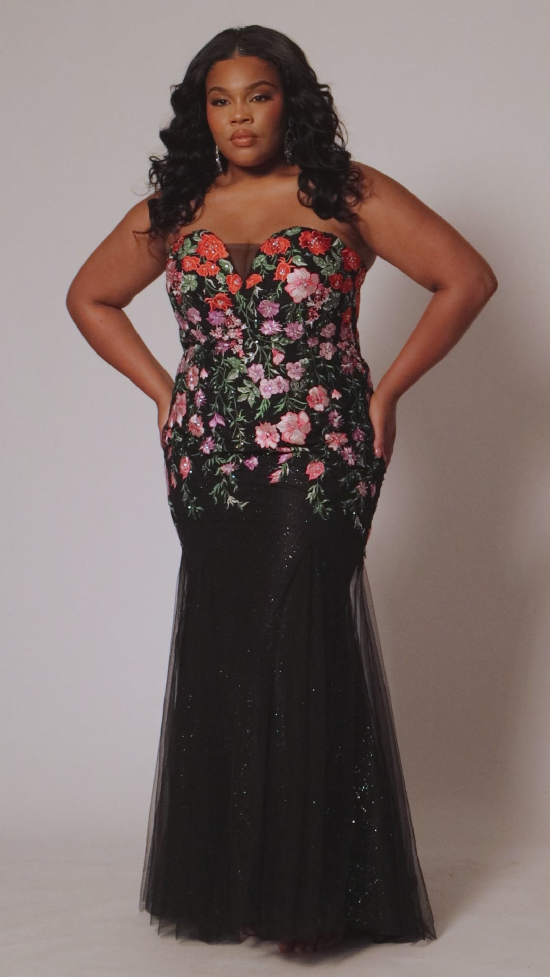 Fitted plus size mermaid gown with red, purple and pink flower embroidered appliques over black sparkle tulle. Strapless sweetheart bodice, center back zipper and fitted slim skirt. Style SC7408 by Sydney's Closet