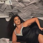 Plus Size satin fitted pleated formal dress with silver beaded straps and V-neckline detail. Pleated bodice, ruching on fitted skirt with slit. Attached overskirt included. Avialablie in fire red, magenta pink, onyx black, and sky blue in plus sizes 14-28. Style TE2513 by Tease Prom. 