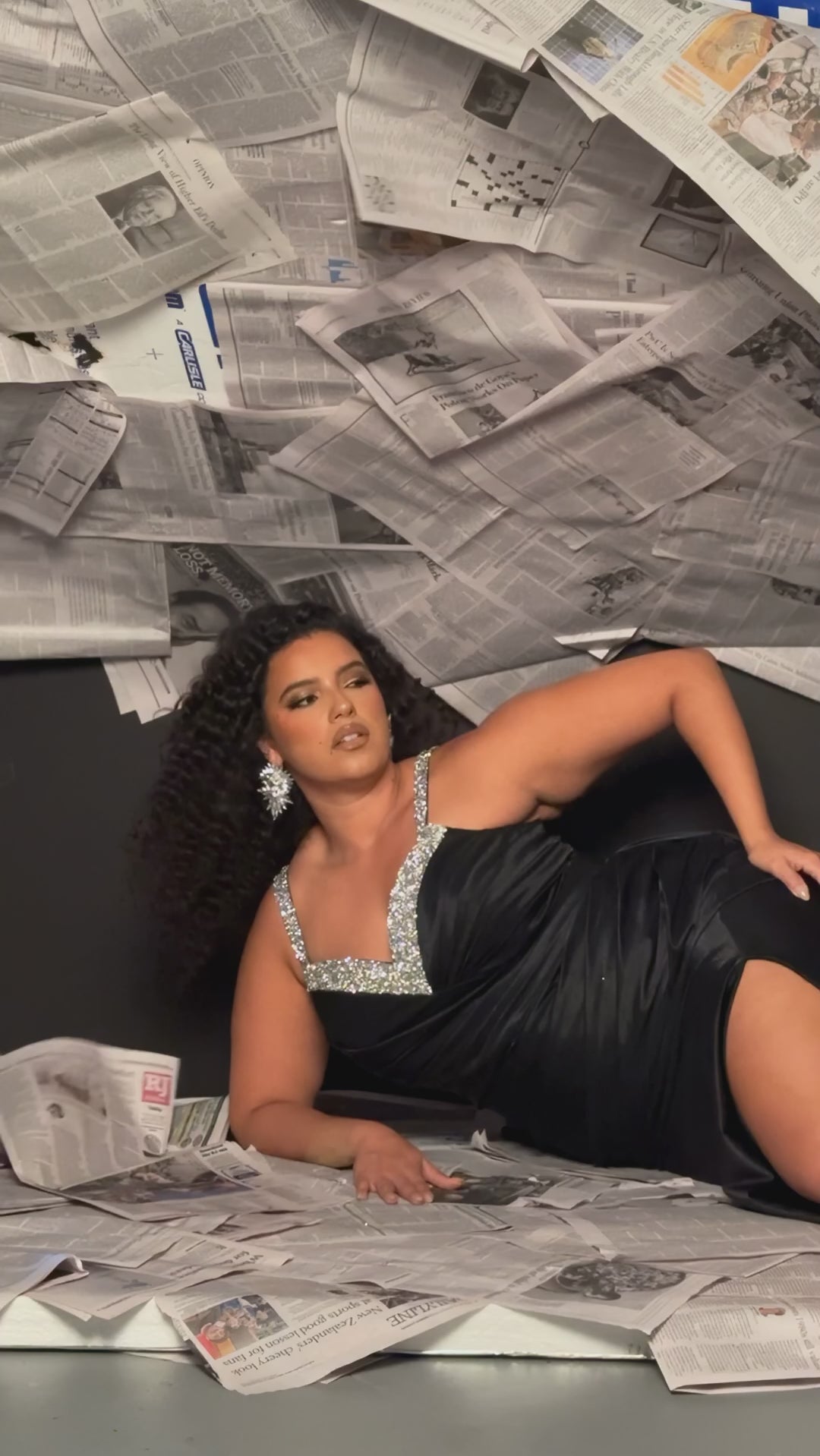 Plus Size satin fitted pleated formal dress with silver beaded straps and V-neckline detail. Pleated bodice, ruching on fitted skirt with slit. Attached overskirt included. Avialablie in fire red, magenta pink, onyx black, and sky blue in plus sizes 14-28. Style TE2513 by Tease Prom. 