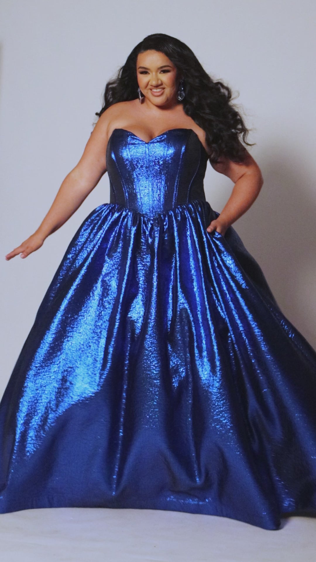 Tease Prom for Sydney's Closet style TE2539 available in ruby red or sapphire blue. Plus size ballgown with strapless sweetheart bodice, exposed boning, basque waist and full A-line skirt with pockets. 