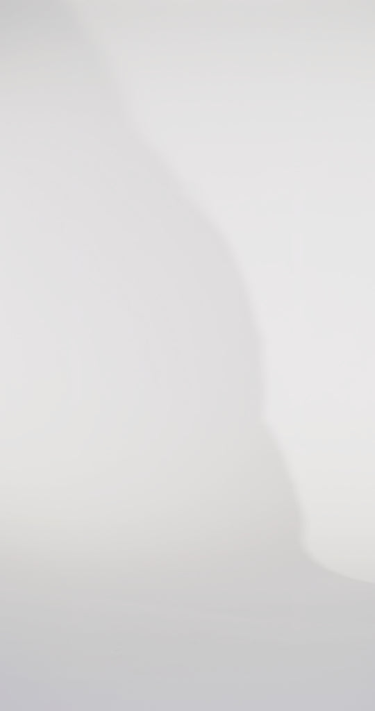 Woman models a slim navy dress with a slit, exposed corset boning, a pleated band over the bust, and rhinestones along the neckline, showing the front and back before walking off screen.