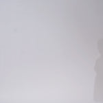 Woman models a white strapless lace tea length dress with a sweetheart neckline and corset bodice, turning to show the back before walking off screen.