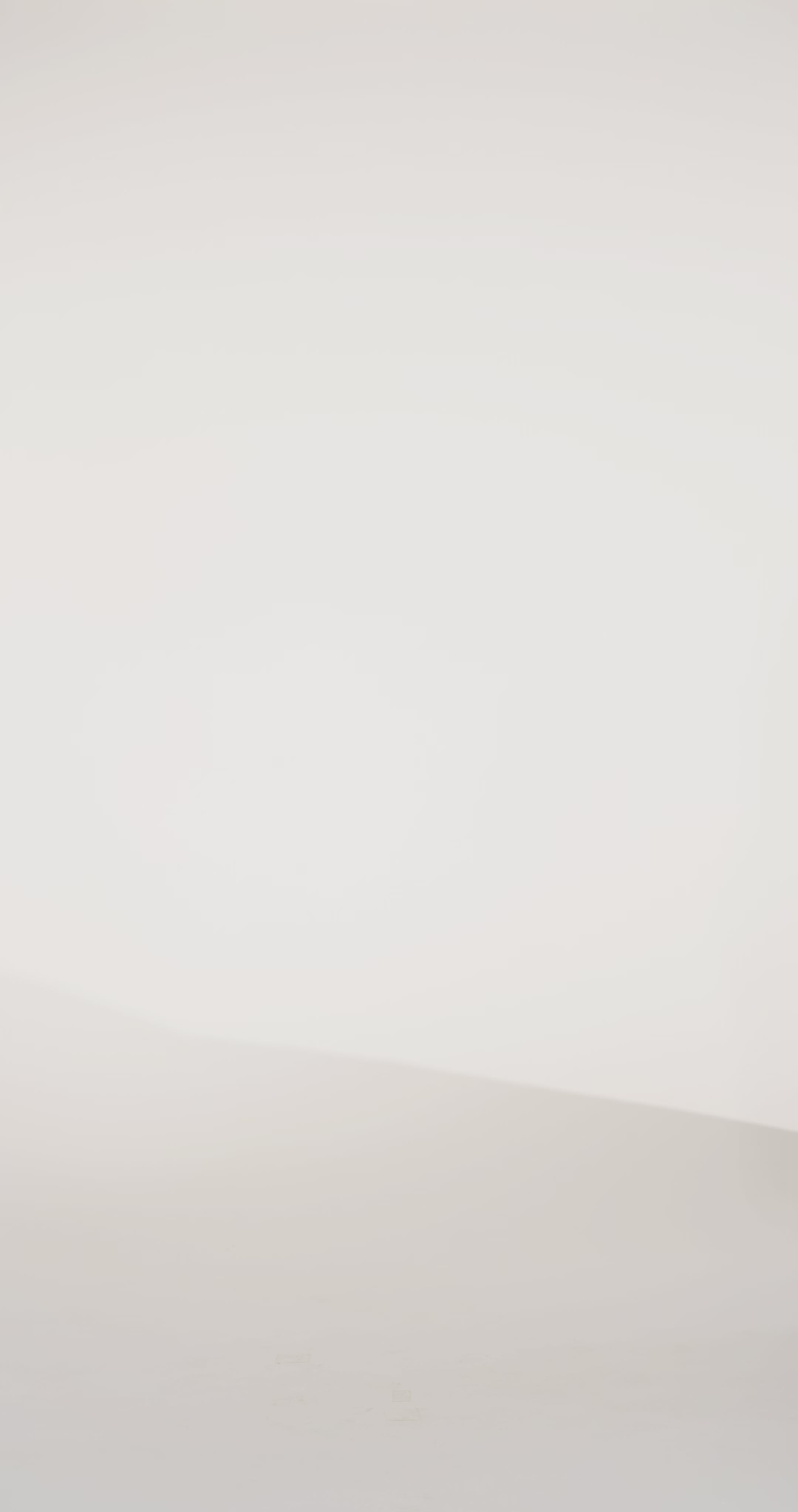 Woman models a strapless blue brocade A-line dress with a slit, turning to show the back before walking off screen.