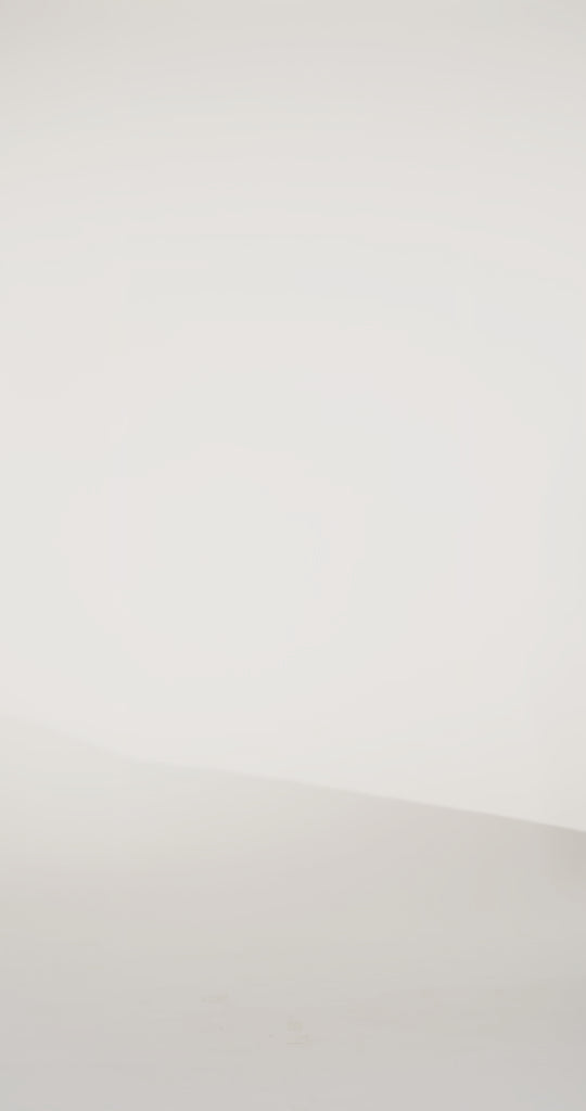 Woman models a strapless blue brocade A-line dress with a slit, turning to show the back before walking off screen.