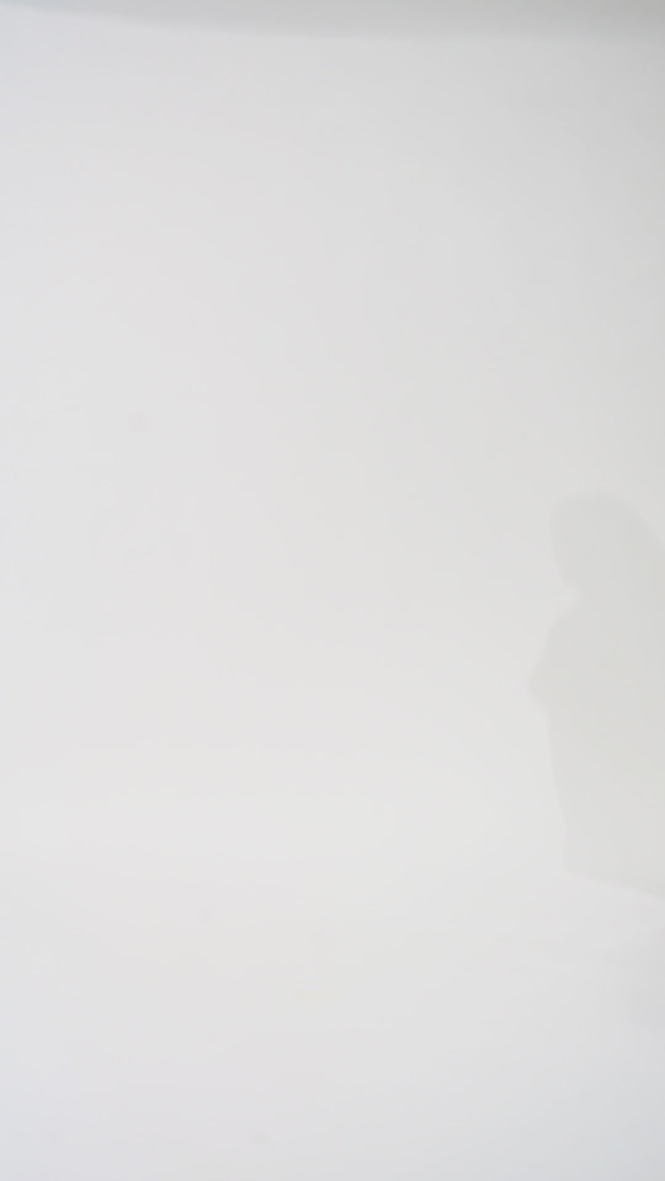 Woman models a black sequin A-line dress with a V-neckline and flowing cape sleeves, turning to show the back before walking off screen.