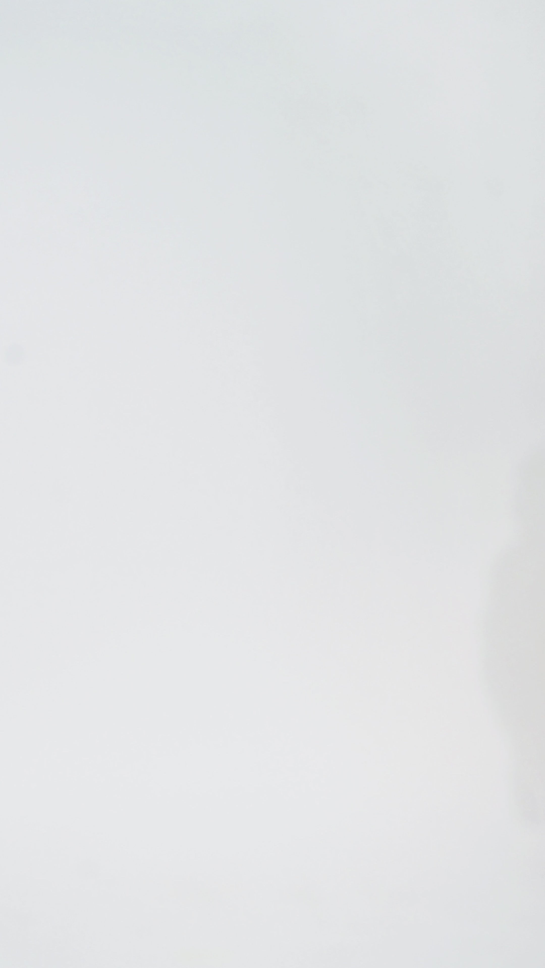 Woman models a black sequin A-line dress with a V-neckline and flowing cape sleeves, turning to show the back before walking off screen.