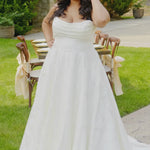 Video of a plus-size bride modeling the MB2601 wedding gown by Michelle Bridal, showcasing the structured bodice, flattering silhouette, and flowing skirt designed for curvy brides.
