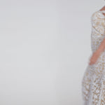 Plus-size woman wearing an off-the-shoulder nude and ivory sequin embroidered formal gown with sweetheart neckline, off-the-shoulder straps and fitted silhouette. CE2611 available from Sydney's Closet