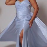 Plus Size satin fitted pleated formal dress with silver beaded straps and V-neckline detail. Pleated bodice, ruching on fitted skirt with slit. Attached overskirt included. Avialablie in fire red, magenta pink, onyx black, and sky blue in plus sizes 14-28. Style TE2513 by Tease Prom. 