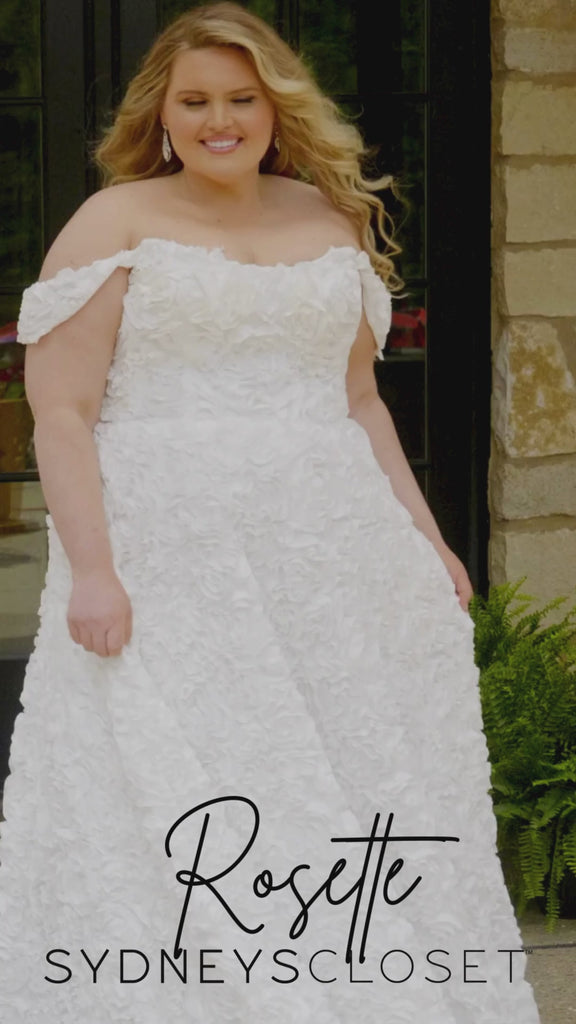 Video montage of a bride modeling a white off-the-shoulder A-line wedding gown with textured floral appliqué throughout, shown outdoors from multiple angles and distances. The text “Rosette” and the “Sydney's Closet” logo appear at the bottom.