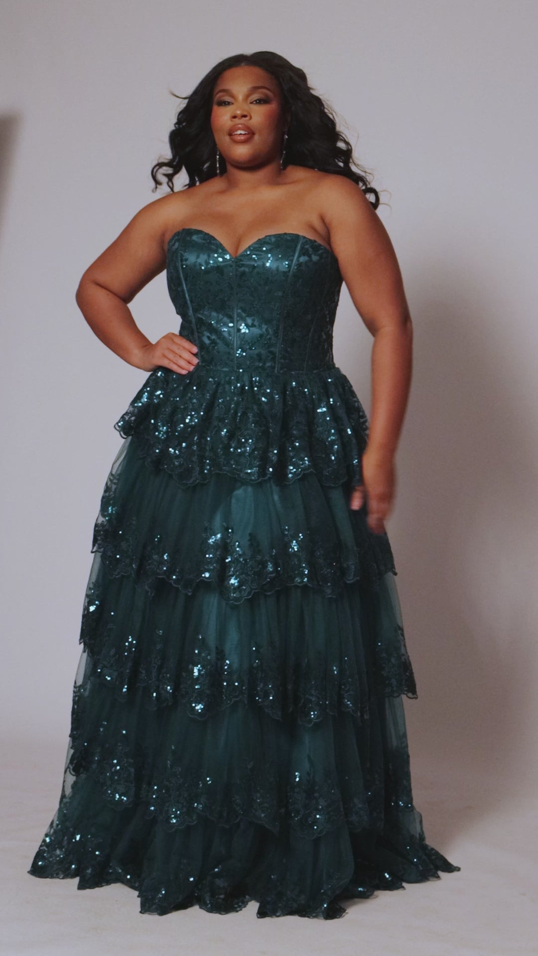 Strapless, sweetheart plus size gala formal ballgown. Exposed corset boning on bodice covered in lace applqiues. Tiered A-line skirt with matching lace applique hem. Style SC7398 is available in forest green, navy blue or burgundy red by Sydney's Closet. 