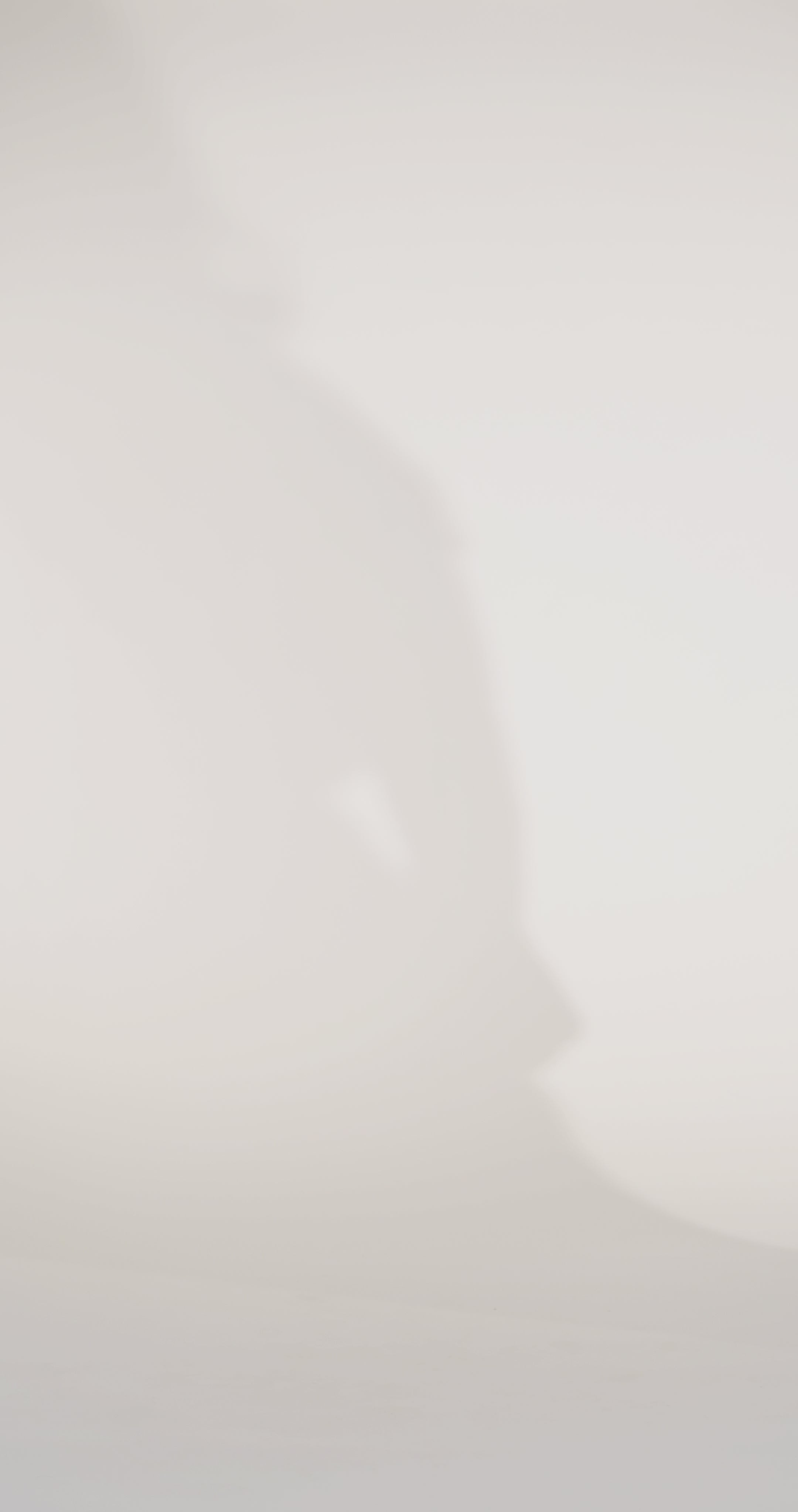 Woman models a green satin slim dress with a slit, off-the-shoulder sleeves, sequin appliqués, beading, and a lace-up back, showing the front and back before walking off screen.