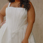 Video montage of a bride modeling an A-line wedding gown with an exposed corset bodice and a subtle floral print, shown outdoors from multiple angles and distances. The text “Selena” and the “Sydney's Closet” logo appear at the bottom.