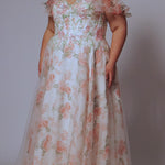 Tease Prom style TE2527 plus size floral prom dress. Printed floral organza with sequin floral leaf appliques.  Spaghetti straps with drape flutter sleeve. Exposed corset boning on bodice. A-line skirt with long invisible center back zipper. 